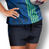 Custom women's rugby shorts in navy blue, featuring a drawstring and a logo. The model holds a rugby ball.
