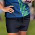 Custom women's rugby shorts in black with a blue and green patterned top. Features a logo on the shorts.