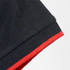 A black polo shirt featuring a red trim on the collar and sleeve. It has a branding logo.