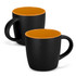 A coffee mug featuring a matte black exterior and a glossy orange interior, with a handle and a logo.