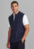 A navy zip-front vest is worn over a white shirt. The model stands against a grey background, featuring a logo on the vest.