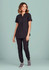 A black women's tunic scrub top is worn with matching pants, featuring a relaxed fit and button detail.