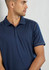 A navy blue short sleeve polo shirt with a collar, featuring a logo on it. The model is looking to the side.