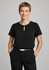 A black short sleeve blouse featuring a keyhole detail at the neckline, paired with black trousers.