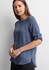 A women's boatneck top in a soft blue shade with rolled sleeves and a slight high-low hem. Features a logo.