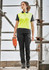 A woman wearing bright yellow and black cargo pants, standing on scaffolding with a power tool, showcasing the cargo pant design.