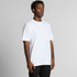 A plain white Staple Raglan Tee displayed on a model, featuring short sleeves and a relaxed fit.