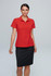 A red polo shirt worn by a model, paired with a black skirt. The shirt features a collar and has a logo.
