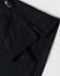 A black polo shirt with a short collar and branded tag detailing at the neckline.