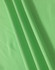 A close-up of soft, textured fabric in vibrant green, showcasing the material of a polo shirt.