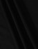 A close-up of black fabric, featuring smooth folds and a soft texture, ideal for a polo shirt.