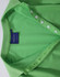 A green Ladies' Truedry Pique Polo shirt features a polo collar and button detail, with a brand label visible.