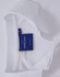 A white polo shirt featuring a tag and a collar. The shirt has buttons and a branding logo.