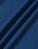 A close-up of a textured fabric in deep blue, featuring soft drapes and folds. The fabric is suitable for polo shirts.