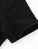 A close-up of a black cotton stretch polo shirt featuring a short sleeve and a rounded hem.