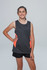 A girl wearing a grey singlet with orange accents stands confidently, paired with black shorts. The image features branding.
