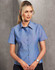 A button-up ladies' short sleeve shirt in chambray blue, featuring a collar and a row of buttons, with a logo.