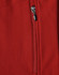 A close-up of a red softshell vest featuring a zippered pocket and a logo.