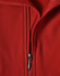A red softshell vest with a zippered front and a fleece interior, featuring a logo.