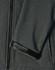 A close-up of a dark grey softshell hoodie highlighting the sleeve cuff with a Velcro adjustment and zipper.