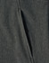 A close-up of a dark green softshell full zip hoodie featuring a zippered pocket and textured fabric.