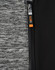 A close-up of a grey and black workwear jacket featuring a zipper and a logo.