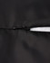 A close-up of a black parka jacket featuring a zipper and seamless design. It includes a logo on the fabric.