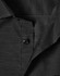 A black long-sleeve button-up shirt featuring a pin dot pattern and a collar, with a logo present.