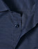 A close-up of a navy blue men's button-up shirt featuring a pin dot pattern and a collar with buttons.