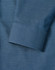 A detailed close-up of a blue men's button-up shirt featuring a pin dot pattern and a cuff.