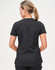 A women’s solid black short-sleeve scrub top featuring a sleek design and a logo on the back.