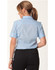 A light blue women's pinstripe short sleeve button-up shirt with a collar and rolled sleeves, featuring a logo.
