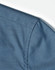 A close-up of a blue pin dot pattern on a 3/4 sleeve shirt, featuring a button-up design.