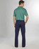 Men's utility cargo pants in navy, paired with a green polo shirt. The pants feature multiple pockets and a logo.