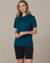 A model wearing dark cargo shorts and a teal polo shirt. The outfit includes a logo on the shirt.