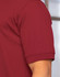 A maroon polo shirt with a short sleeve and a logo on the chest. The fabric appears smooth and lightweight.