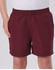 Kids microfibre sports shorts in a deep burgundy colour, featuring an elastic waistband and side pockets.