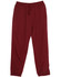 Burgundy track pants with an elasticated waistband, featuring side pockets and a drawstring, with a logo present.
