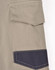 A close-up of unisex cotton stretch drill cuffed work pants in light khaki with a dark navy pocket detailing.