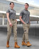 Unisex cotton stretch drill cuffed work pants in khaki, modelled by two people wearing grey tops and work boots.