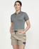 A woman wearing unisex cotton stretch drill shorts in beige, paired with a grey polo shirt. The shorts feature pockets and a drawstring.