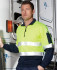 A fleecy sweat in fluorescent yellow and navy, featuring a zip neck and reflective stripes. Includes a branding logo.