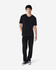 A black Gildan Softstyle adult v-neck t-shirt displayed on a model, paired with black jeans and sneakers.