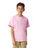 A pink youth short sleeve t-shirt displayed on a person, featuring a simple design and a logo.