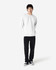 A white Gildan Softstyle adult sweatshirt displayed on a model, paired with black jeans and sneakers.