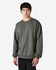A dark green Gildan Softstyle adult sweatshirt on a model, featuring a casual design and long sleeves.