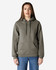 A hooded sweatshirt in khaki green, featuring a front pocket and a logo, worn by a model.