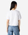 A white women's boxy t-shirt from American Apparel, featuring a plain back, paired with denim jeans.