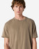 A unisex garment dyed heavyweight cotton t-shirt in a neutral brown colour, featuring a simple design and crew neck.