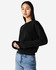A women's black crewneck sweatshirt displayed on a model, featuring long sleeves and a relaxed fit.